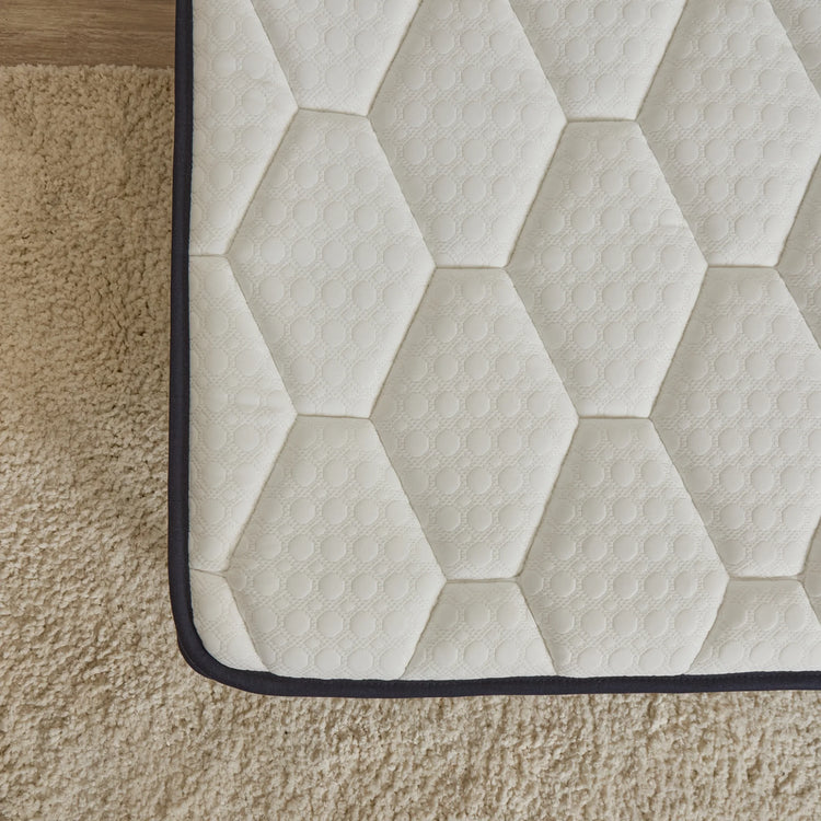 Hexagonal patterned rug on a wooden floor