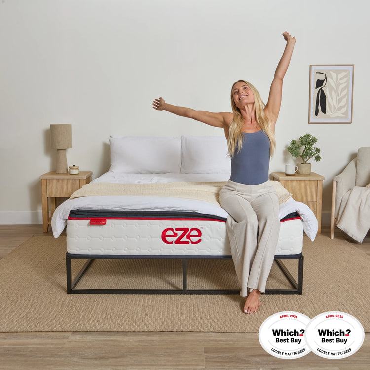 EZE HYBRID ULTRA MATTRESS WITH FEMALE MODEL STRETCHING ON THE EDGE OF THE BED