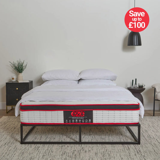 Mattress on a bed with 'e-Zee' branding and a promotional offer in a bedroom setting.