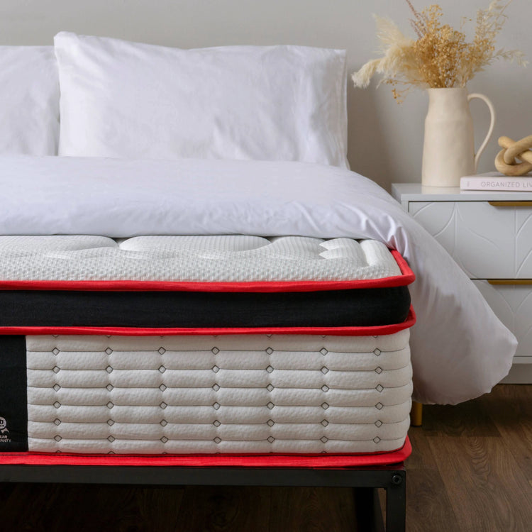 eze Mattress with red border on a bed in a bedroom setting