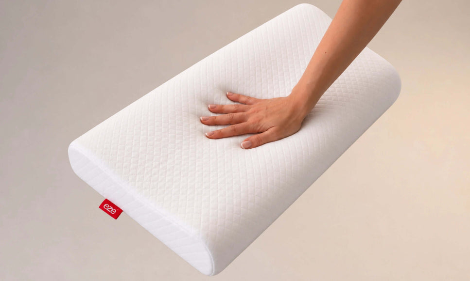 hand touching the eze comfort memory foam pillow