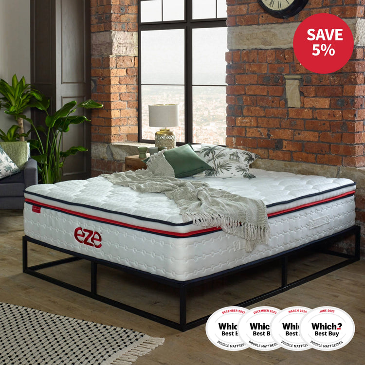 eze hybrid max mattress on a black metal bedframe with underbed storage against an exposed brick wall with 4 which logosand a 5% off red logo