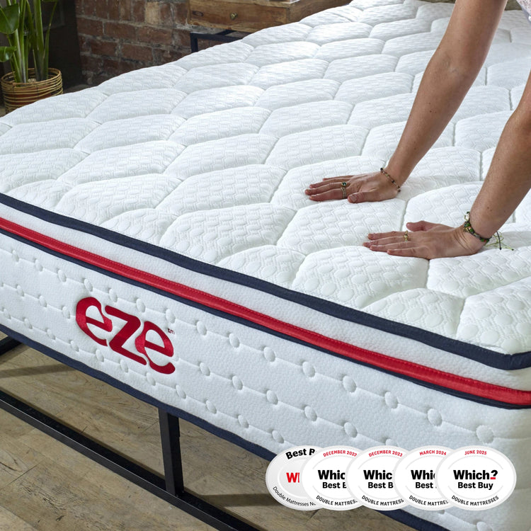 eze™ Hybrid Max Mattress on a black metal bed frame with a person pressing down to show firmness; awarded Which? Best Buy 2023 for double mattresses.