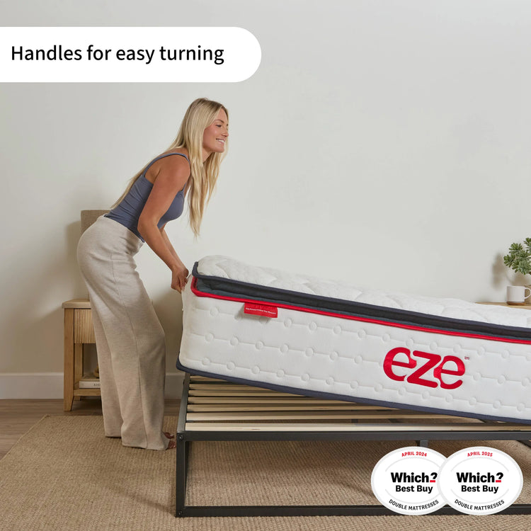 Woman pushing a mattress with 'eze' branding and handles for easy turning.