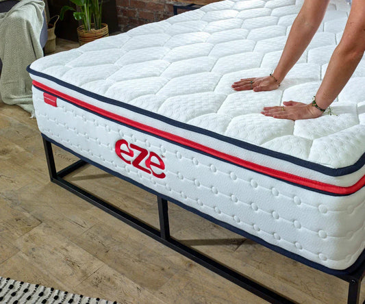 eze hybrid max mattress with womens hands touching the surface