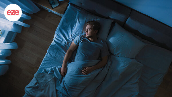 man_in_bed_sleeping_at_night