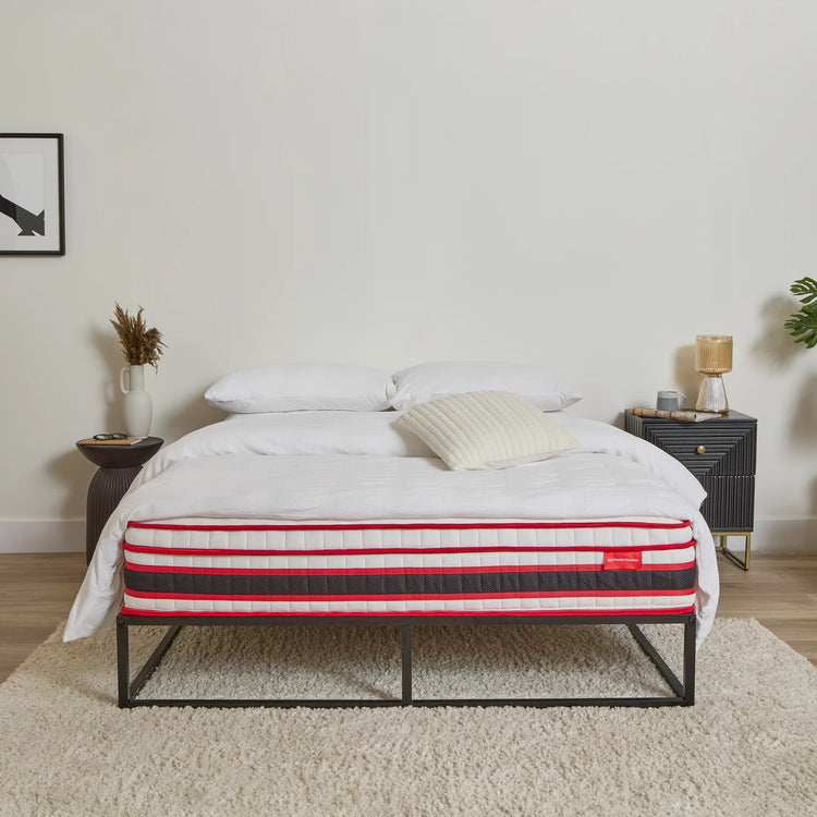 Bed with a EZE striped mattress in a bedroom setting