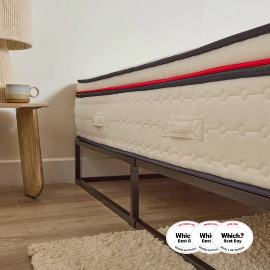 eze mattress on a metal bed frame with 'Which?' award badges in a bedroom setting.