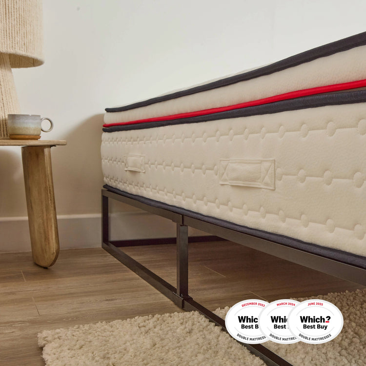 eze mattress on a metal bed frame with 'Which?' award badges in a bedroom setting.