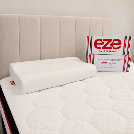 eze comfort pillow on a bed with eze comfort pillow box in the background