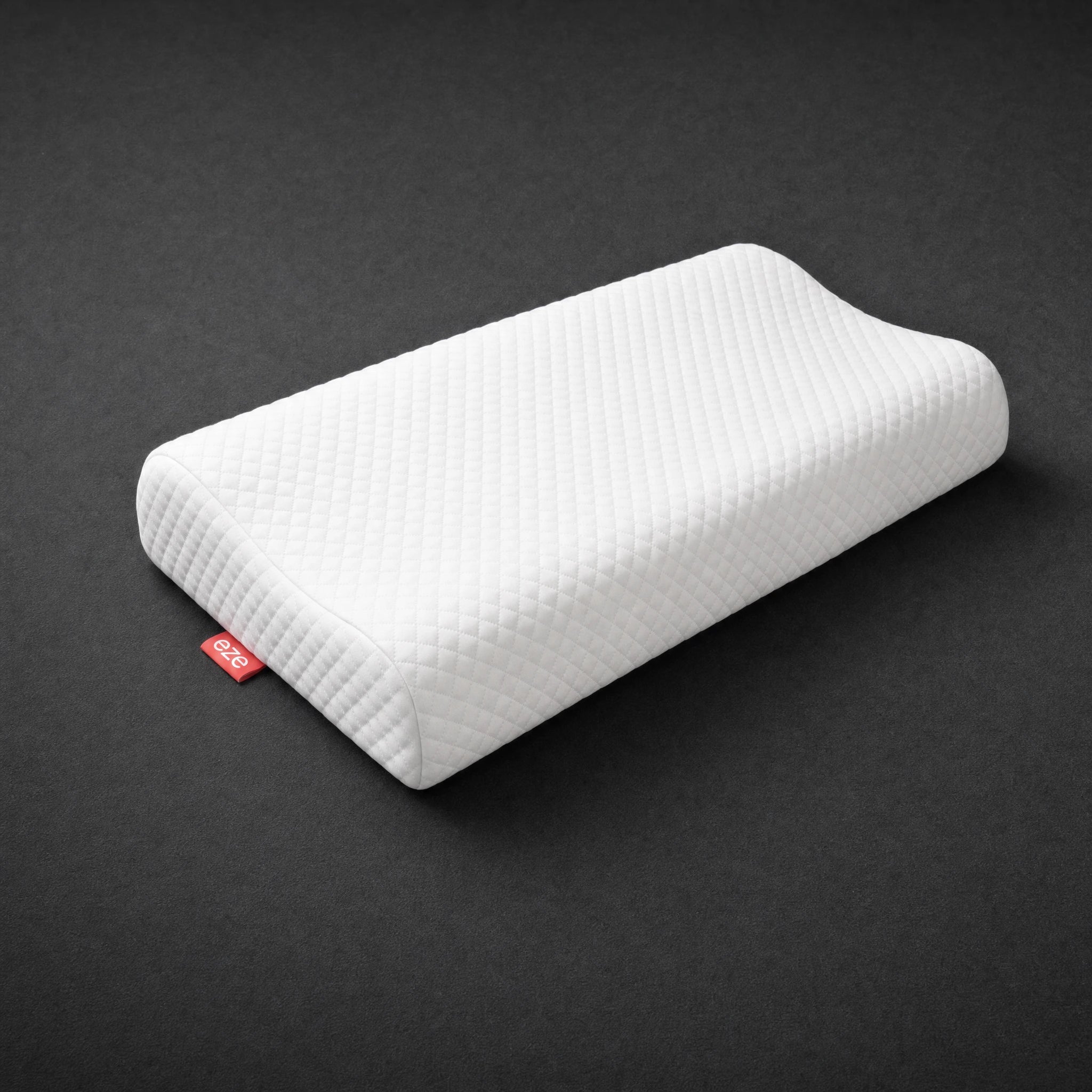 White eze comfort memory foam pillow with a red eze tag on a dark gray background