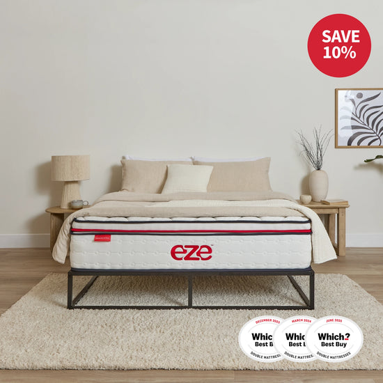 Mattress on a bed with 'eze' branding and multiple awards displayed, in a bedroom setting.