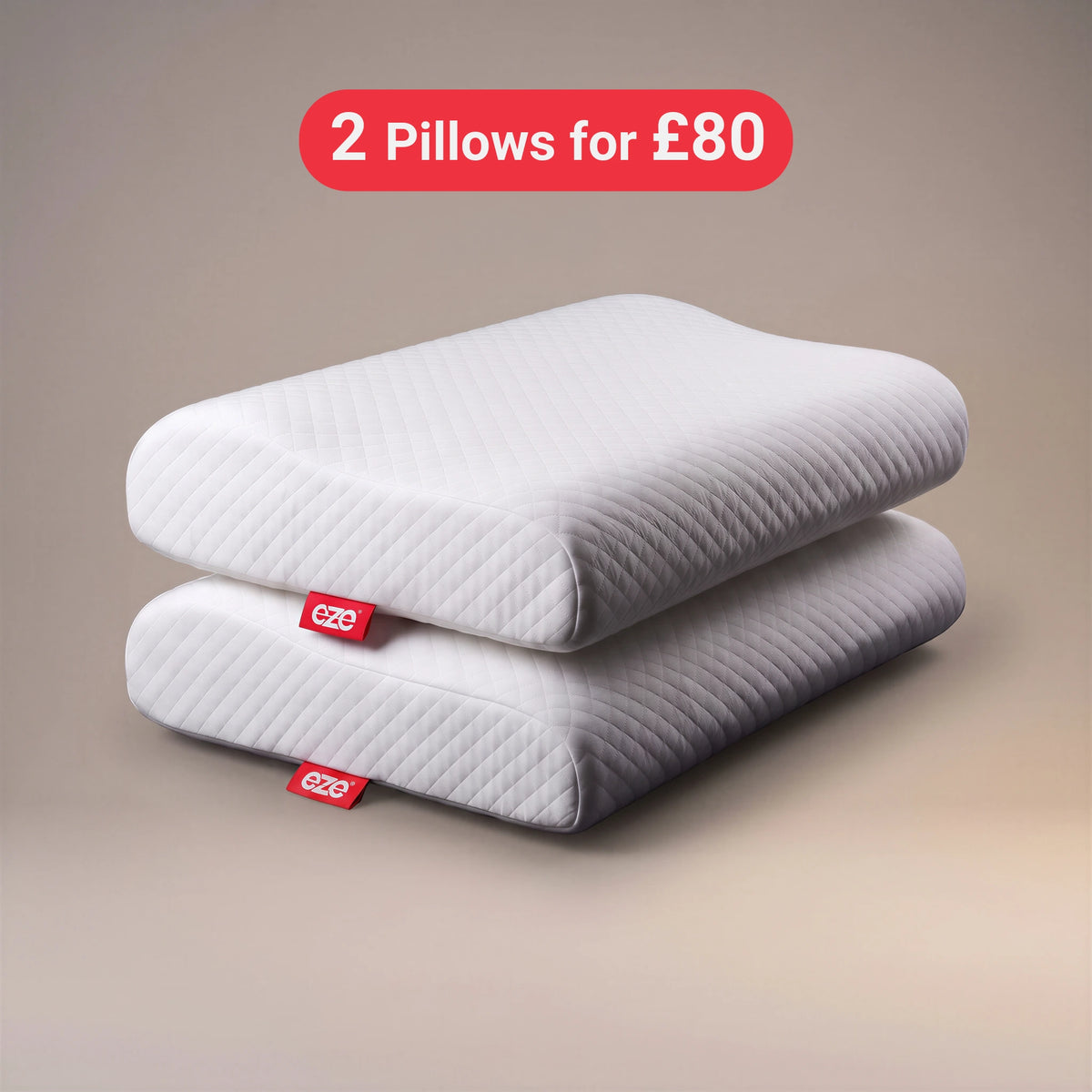 Two white quilted memory foam EZE pillows stacked on a beige gradient background with a red promotional badge that reads '2 Pillows for £80'. Each pillow has a small red eze fabric tag with the brand name 'eze'.
