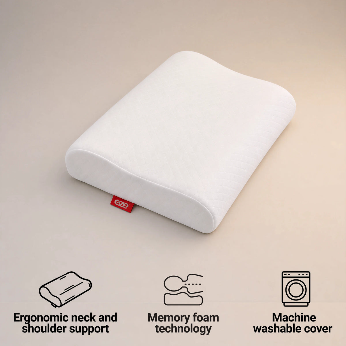 A white ergonomic pillow with a small red eze tag, shown on a beige background with feature icons below reading 'Ergonomic neck and shoulder support', 'Memory foam technology', and 'Machine washable cover'.